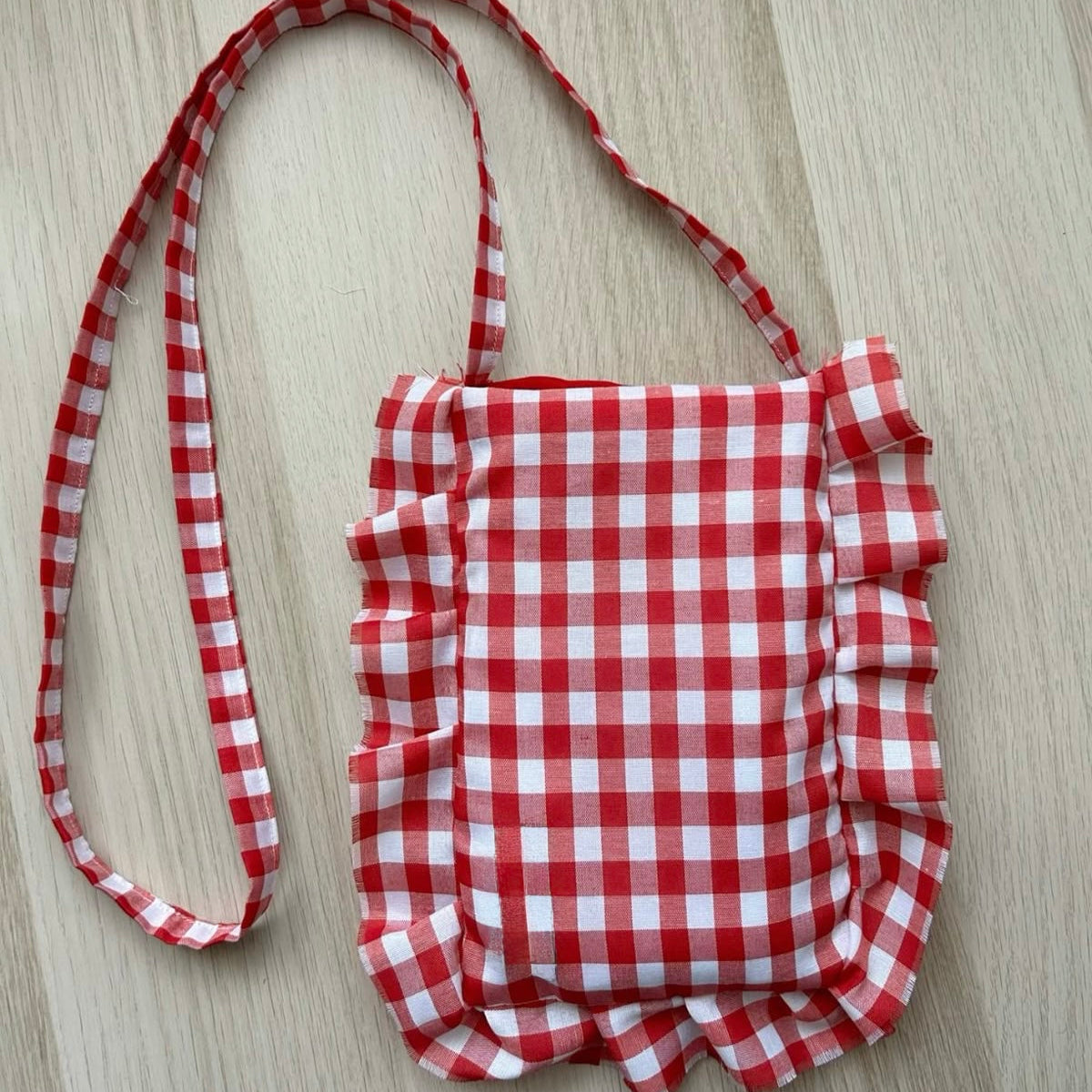 RED AND WHITE SLING BAG